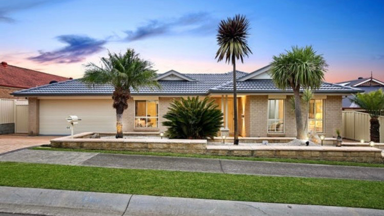 Home with a restored dark grey tile roof at dusk