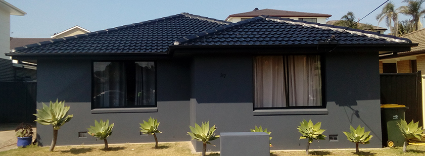 Single storey home with a near-black tile roof